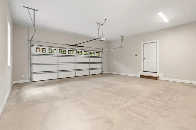 a view of an empty room with a fireplace and a window