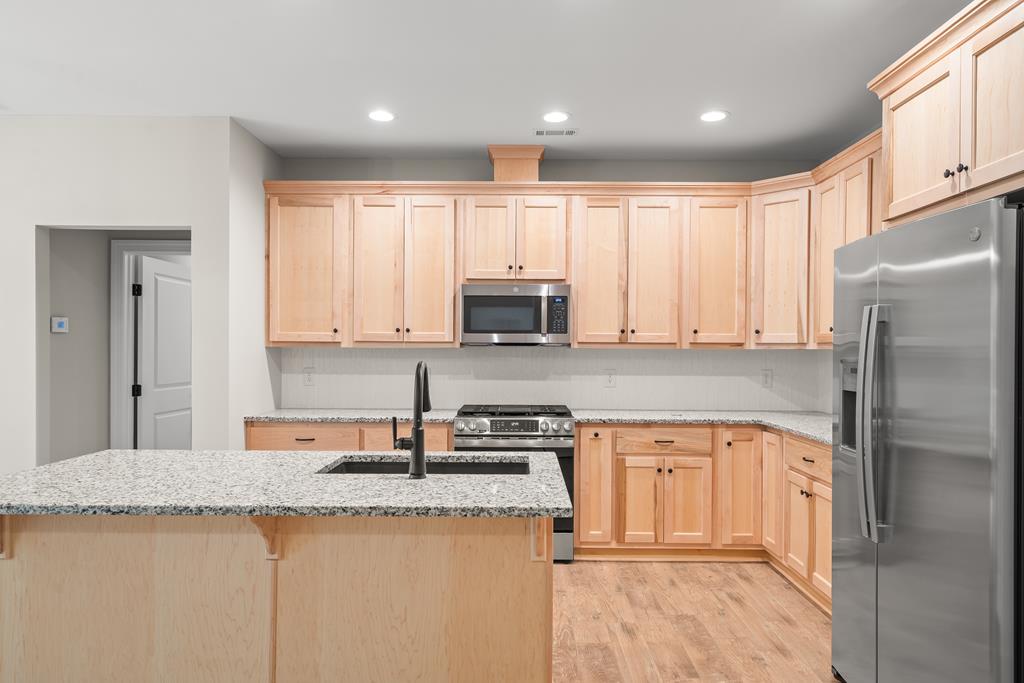 10 West Hawks Nest Road Blairsville, GA 30512 - Photo 38 of 40 a kitchen with stainless steel appliances granite countertop a refrigerator stove top oven and sink