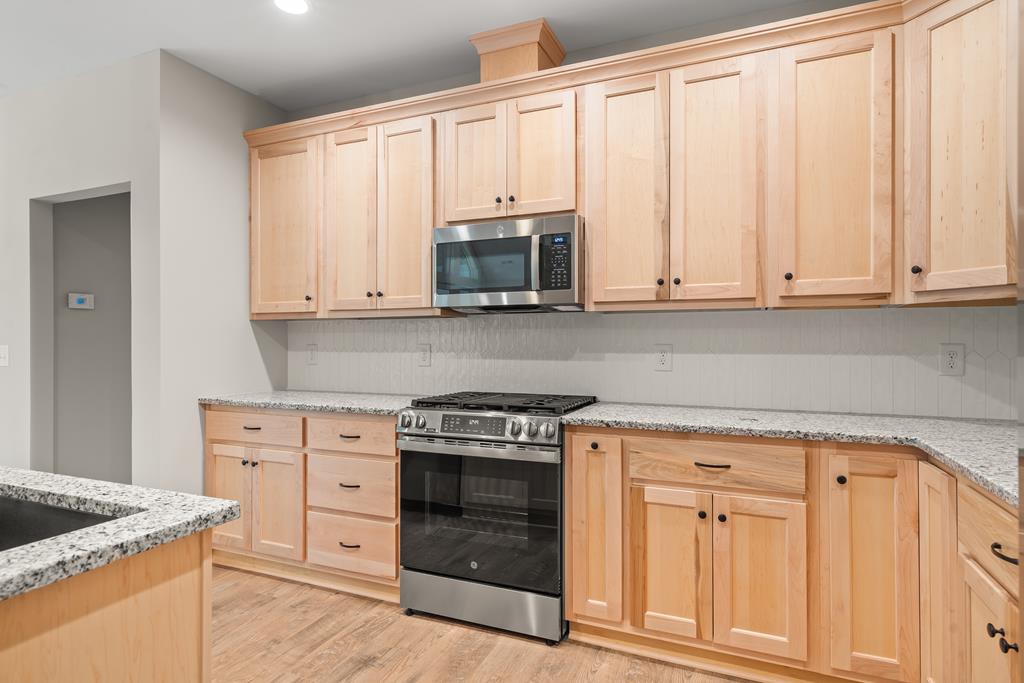 10 West Hawks Nest Road Blairsville, GA 30512 - Photo 39 of 40 a kitchen with granite countertop white cabinets and stainless steel appliances