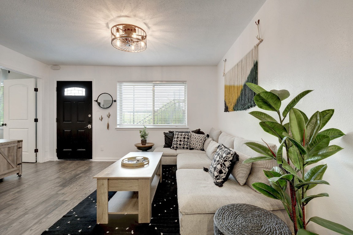 1202 Newning Avenue, Unit 202 Austin, TX 78704 - Photo 1 of 20 Living room featuring wood finished floors and a textured ceiling
