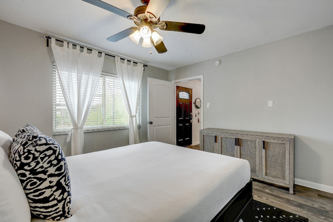 1202 Newning Avenue, Unit 202 Austin, TX 78704 - Photo 15 of 20 Bedroom featuring a ceiling fan and wood finished floors