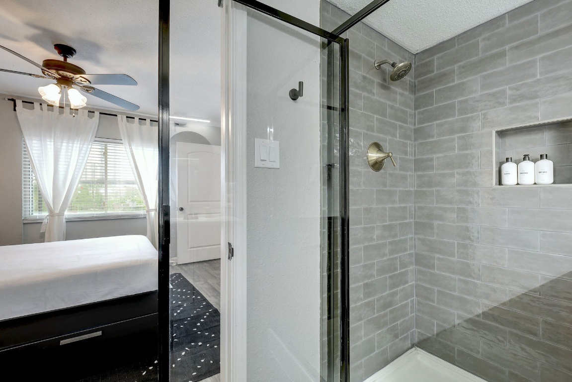 1202 Newning Avenue, Unit 202 Austin, TX 78704 - Photo 17 of 20 Ensuite bathroom featuring a shower stall and ceiling fan