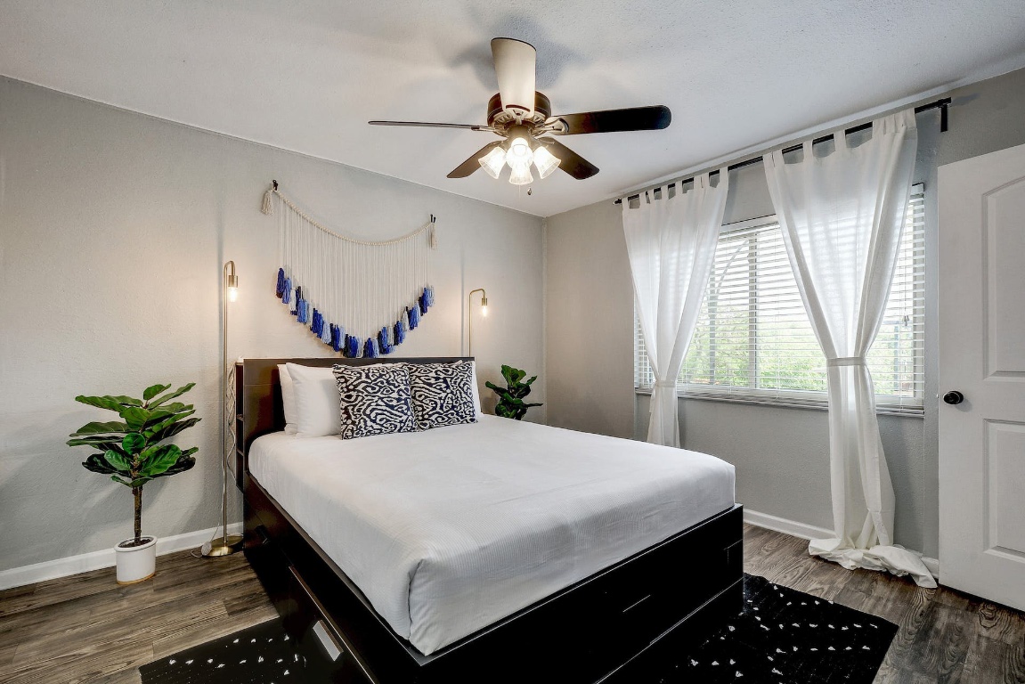 1202 Newning Avenue, Unit 202 Austin, TX 78704 - Photo 3 of 20 Bedroom featuring dark wood-type flooring and ceiling fan