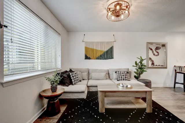 a living room with furniture and a potted plant