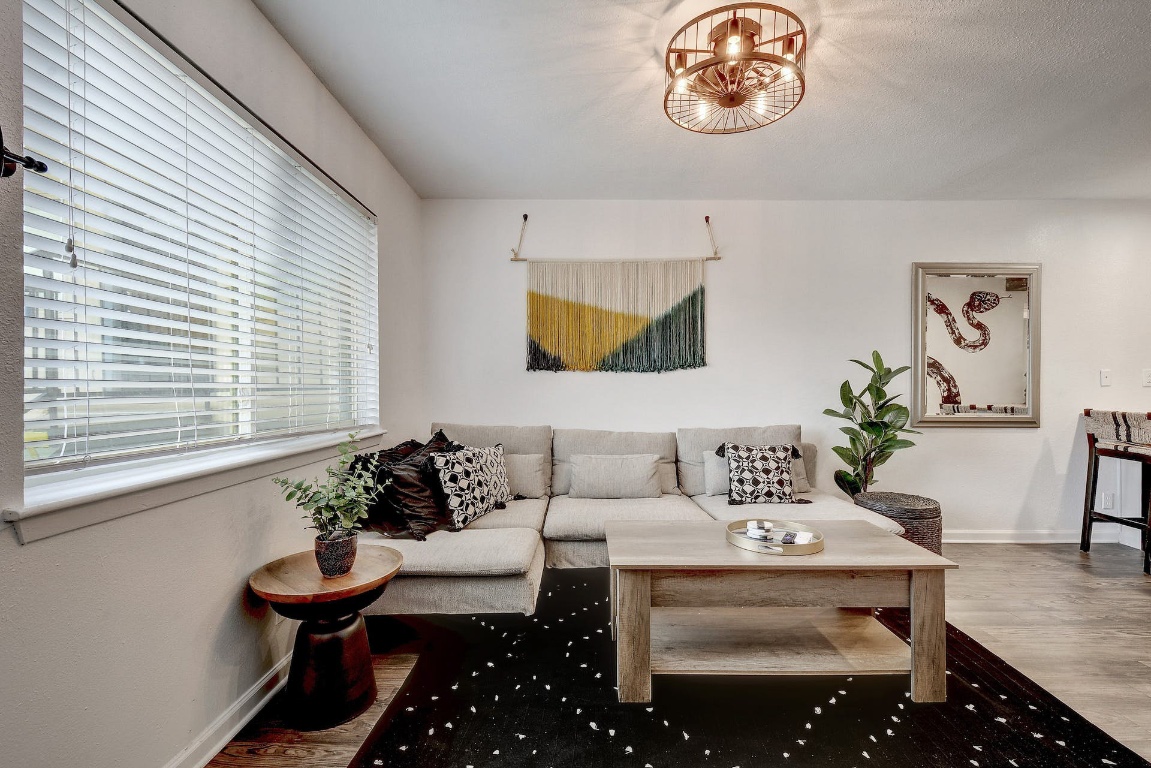 1202 Newning Avenue, Unit 202 Austin, TX 78704 - Photo 7 of 20 Living area featuring wood finished floors and baseboards