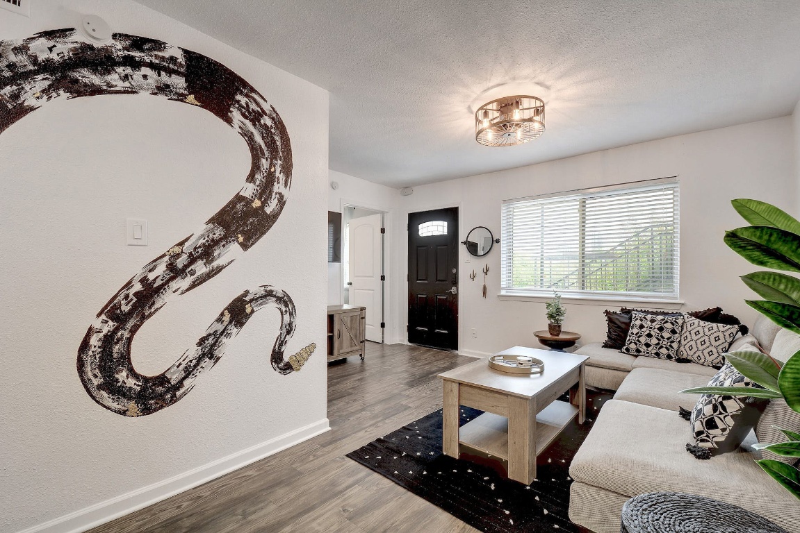 1202 Newning Avenue, Unit 202 Austin, TX 78704 - Photo 9 of 20 Living area featuring wood finished floors and a textured ceiling
