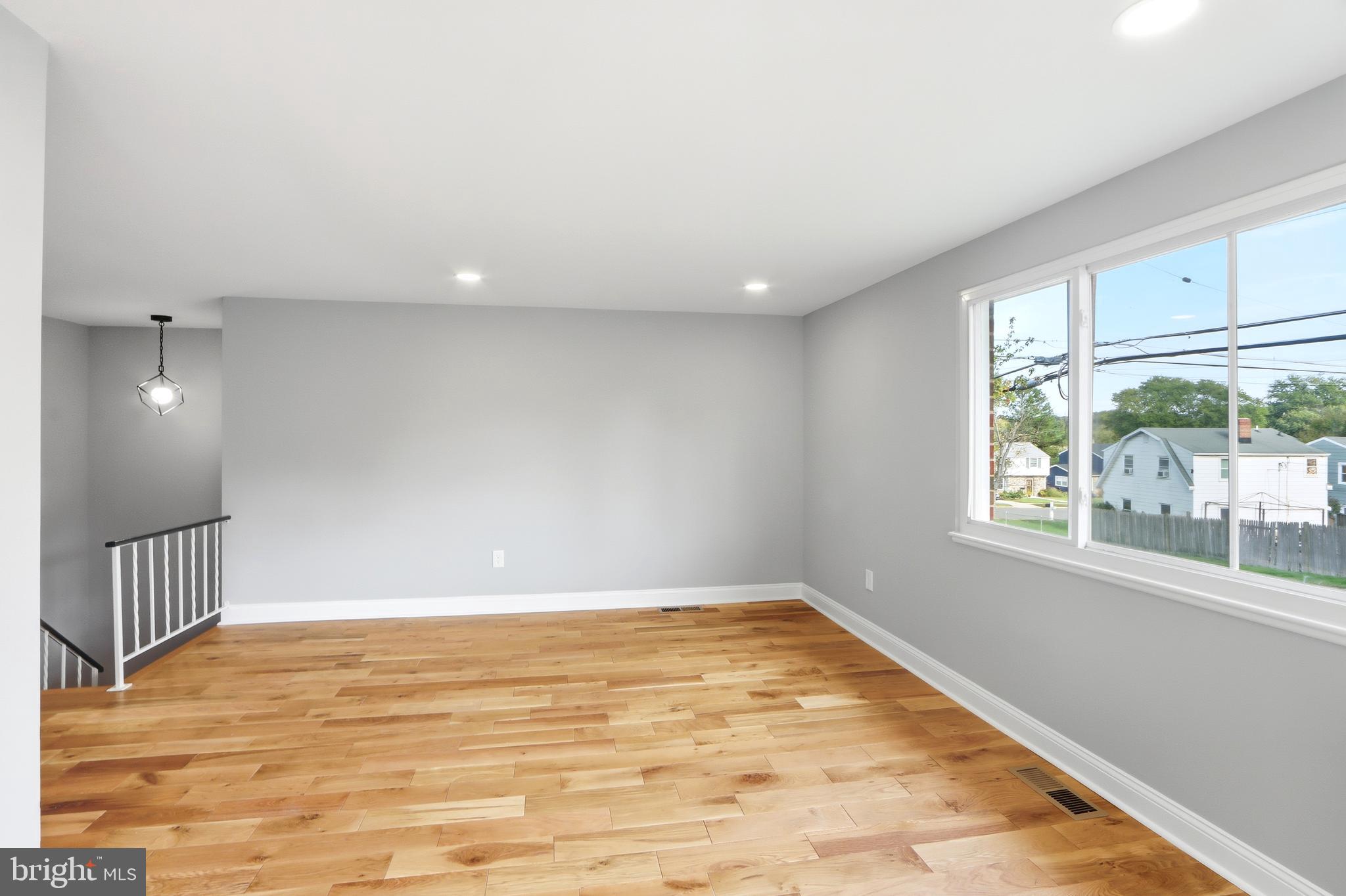 5006 Shelbourne Road Halethorpe, MD 21227 - Photo 11 of 48 a view of an empty room with wooden floor and a window