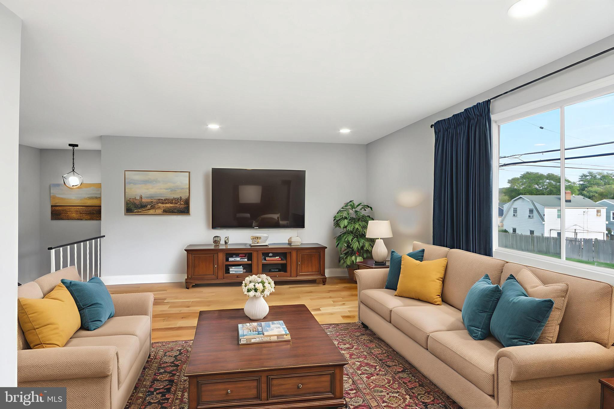 5006 Shelbourne Road Halethorpe, MD 21227 - Photo 12 of 48 a living room with furniture a flat screen tv and a large window