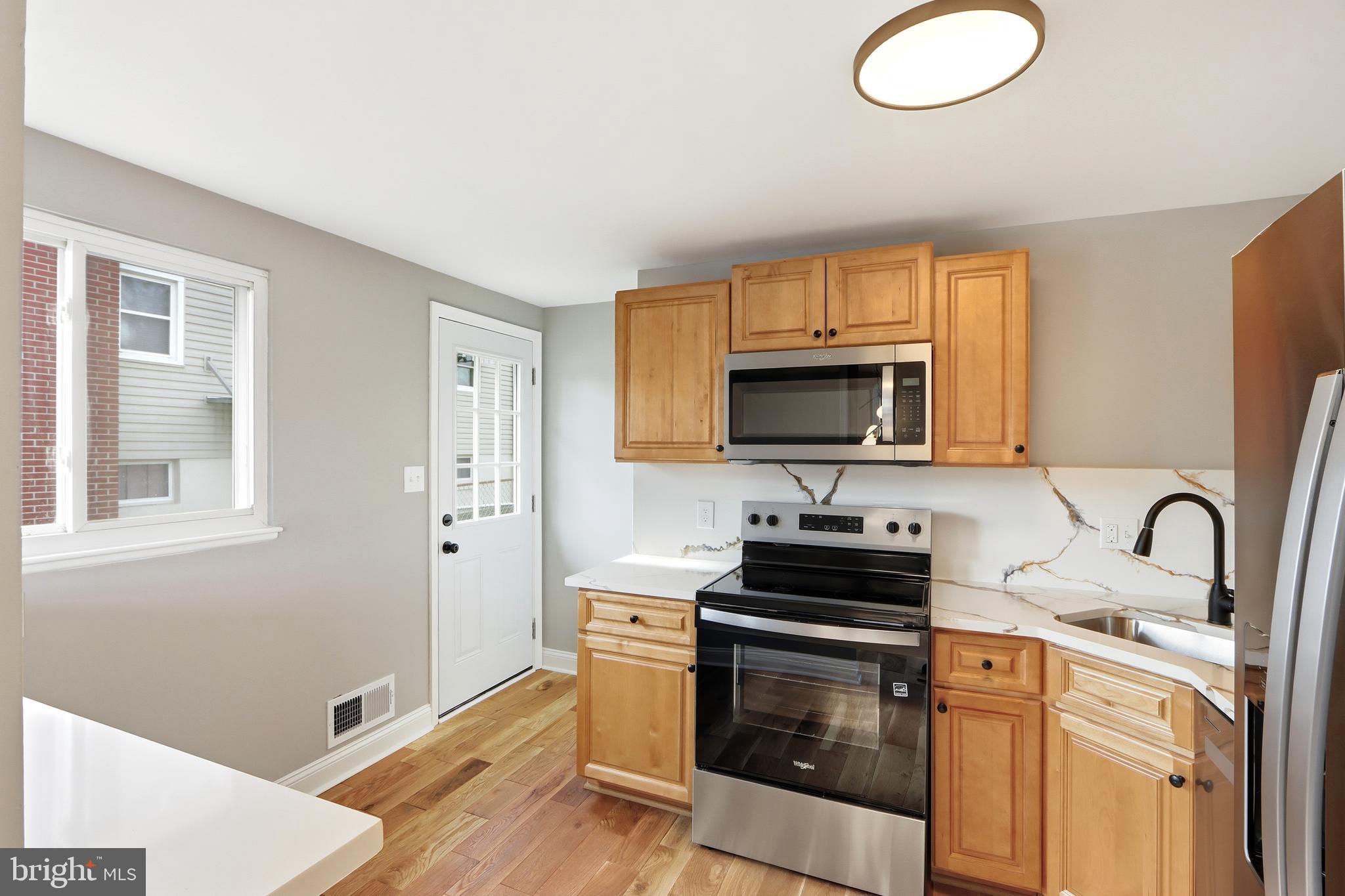5006 Shelbourne Road Halethorpe, MD 21227 - Photo 17 of 48 a kitchen with granite countertop a stove and a sink