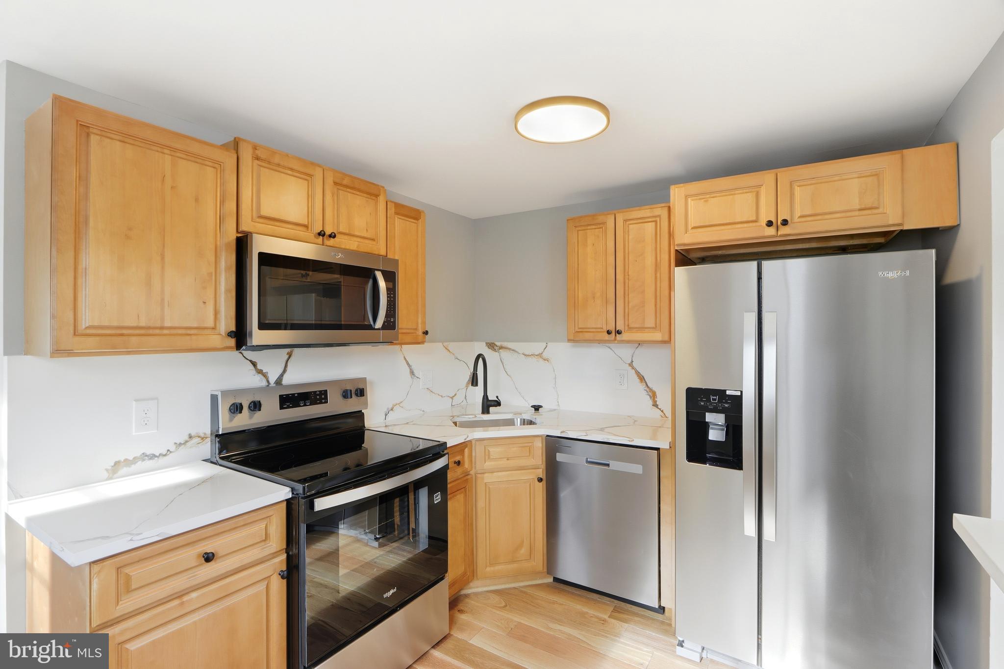 5006 Shelbourne Road Halethorpe, MD 21227 - Photo 18 of 48 a kitchen with a sink a stove and refrigerator