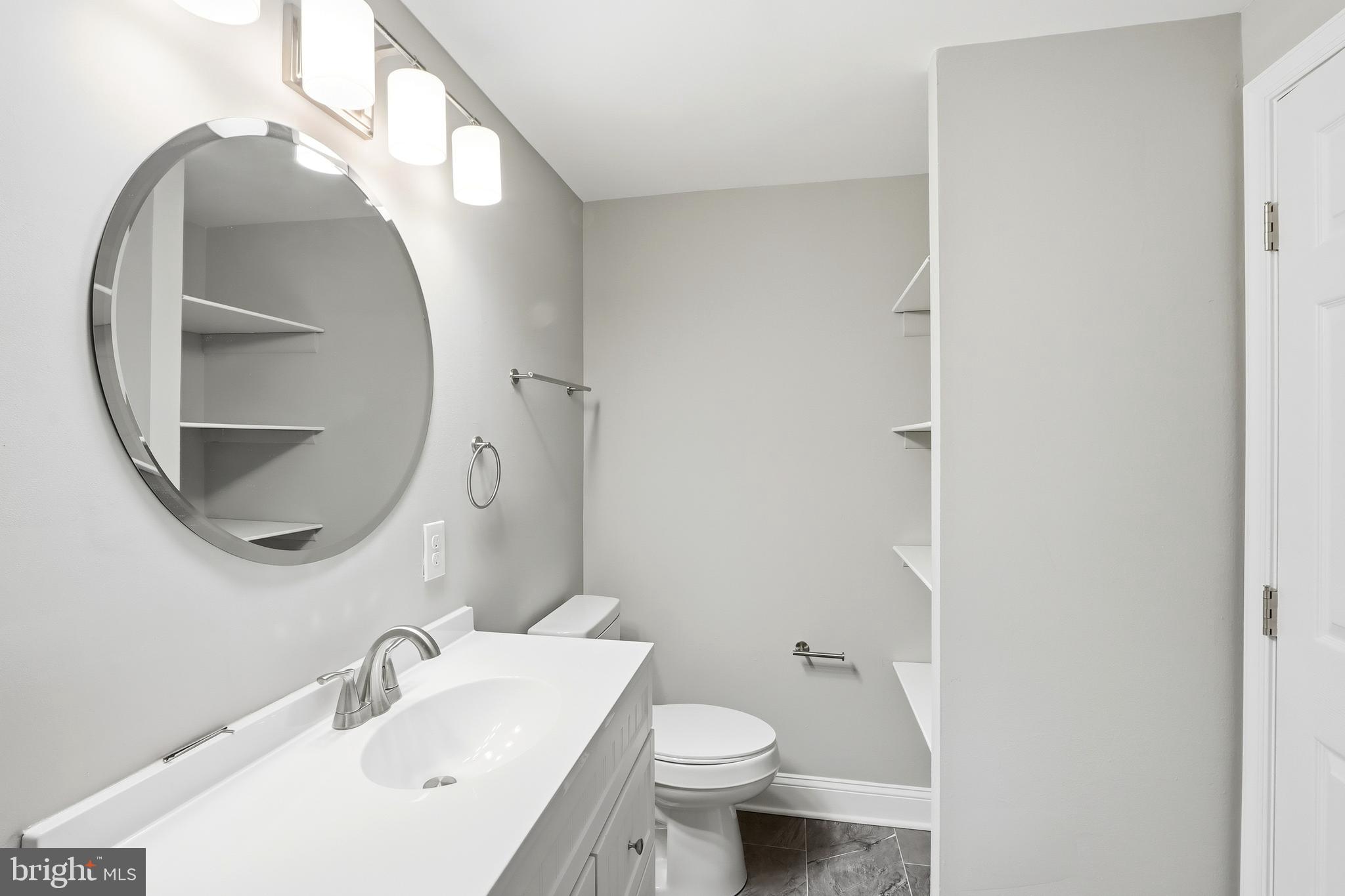 5006 Shelbourne Road Halethorpe, MD 21227 - Photo 23 of 48 a bathroom with a sink and a mirror