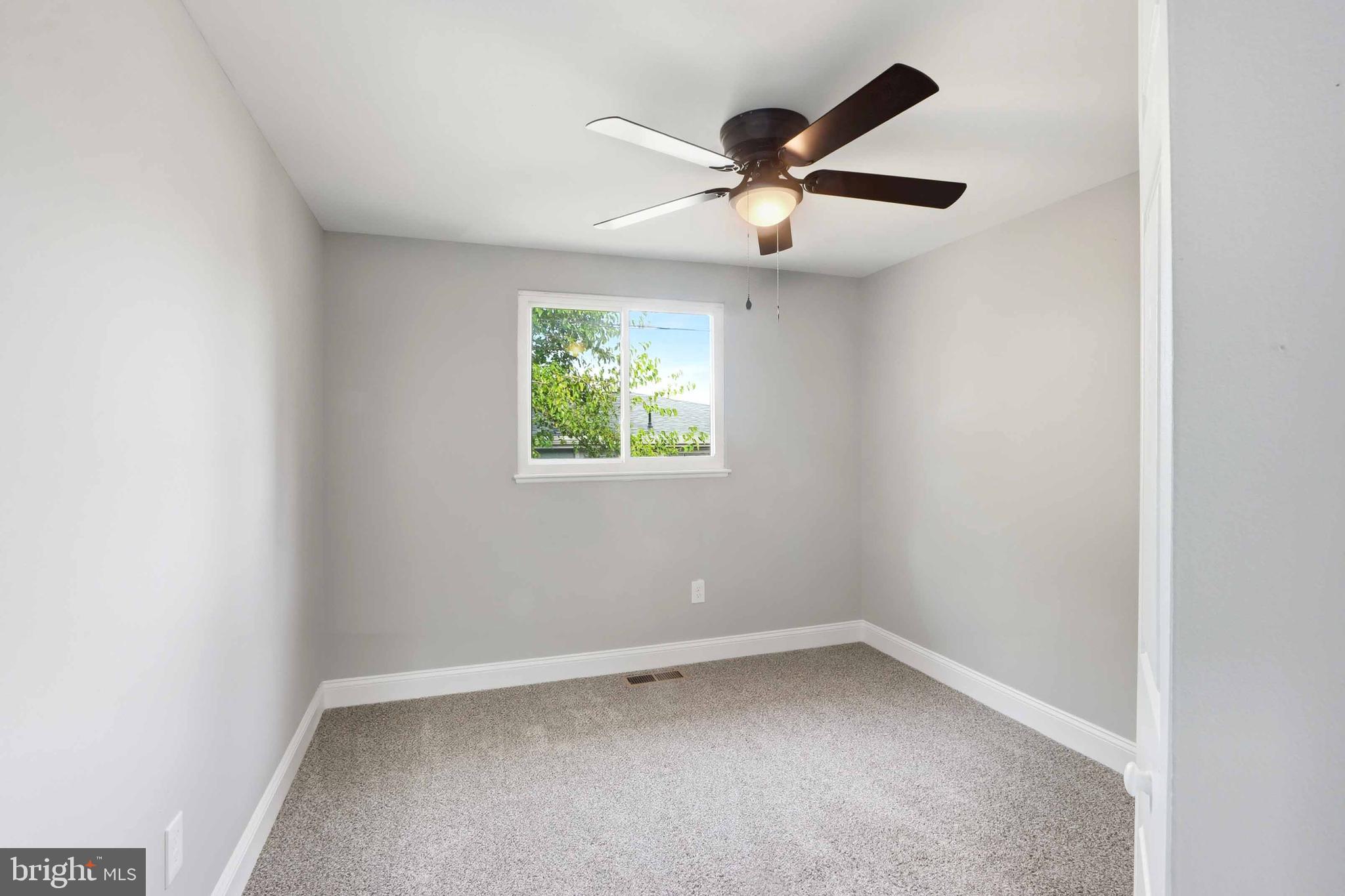 5006 Shelbourne Road Halethorpe, MD 21227 - Photo 24 of 48 an empty room with windows and fan