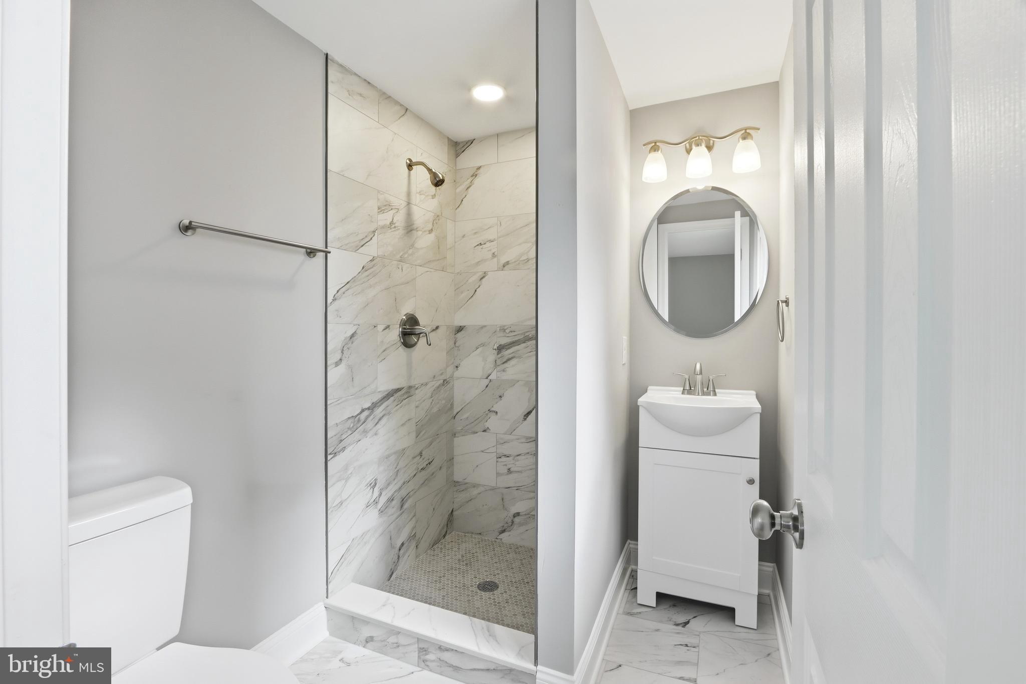 5006 Shelbourne Road Halethorpe, MD 21227 - Photo 35 of 48 a bathroom with a shower a toilet and a sink