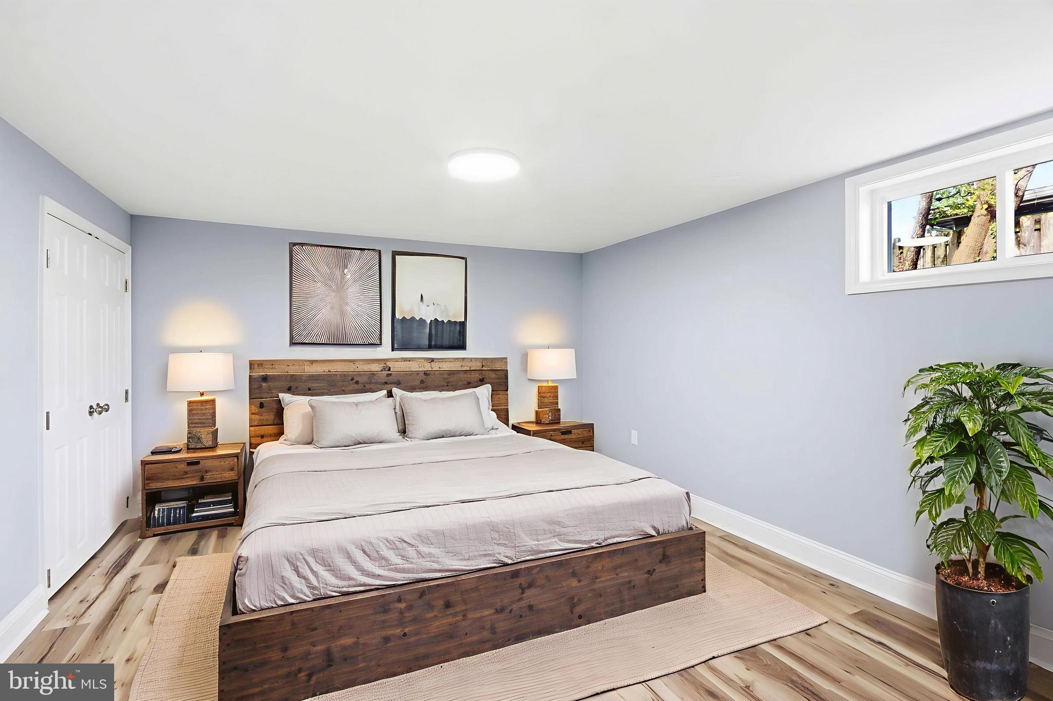 5006 Shelbourne Road Halethorpe, MD 21227 - Photo 43 of 48 a bedroom with a bed and a potted plant