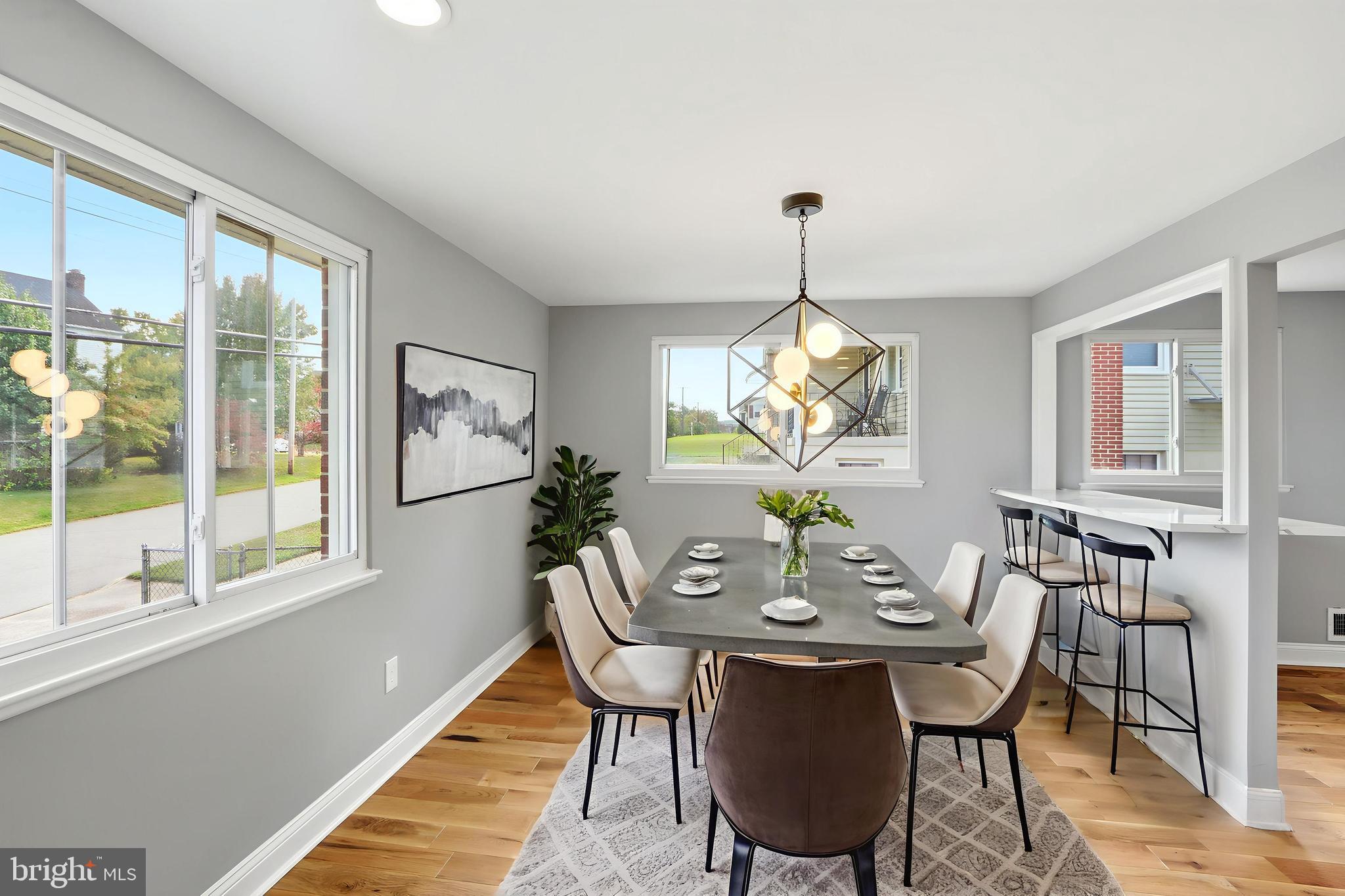 5006 Shelbourne Road Halethorpe, MD 21227 - Photo 8 of 48 a dining room with furniture a chandelier and wooden floor
