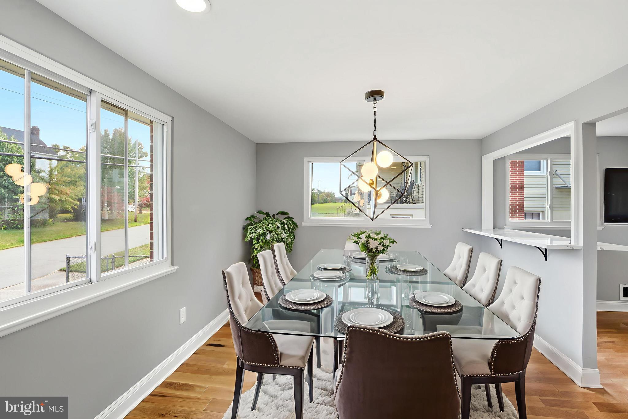 5006 Shelbourne Road Halethorpe, MD 21227 - Photo 9 of 48 a dining room with furniture a chandelier and wooden floor