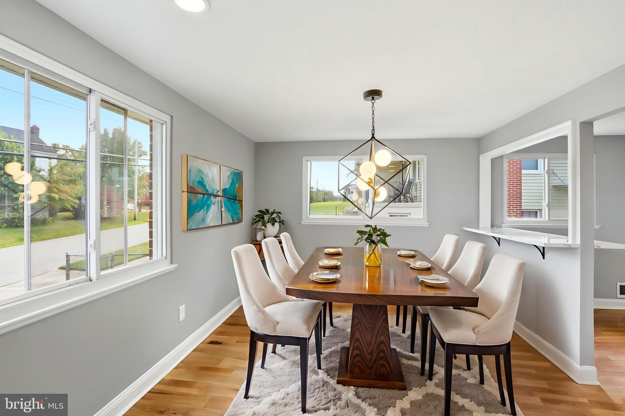 5006 Shelbourne Road Halethorpe, MD 21227 - Photo 10 of 48 a dining room with furniture a chandelier and wooden floor