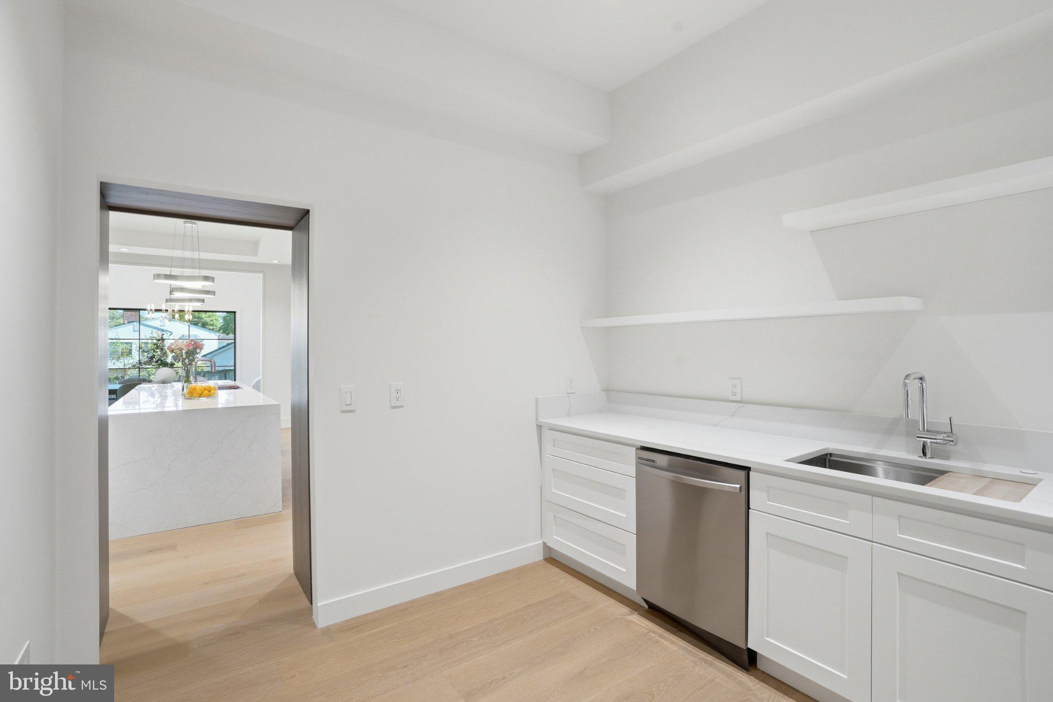 7421 Magarity Road Falls Church, VA 22043 - Photo 37 of 66 Sleek, modern kitchen with bright finishes.