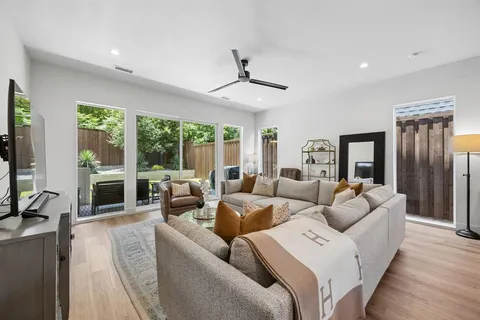 a living room with furniture and large windows