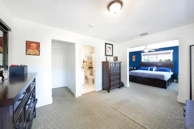 a bathroom with a granite countertop sink toilet and a mirror