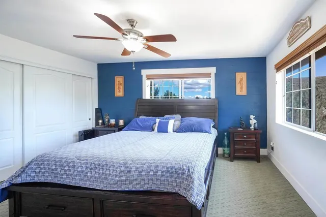 a bedroom with a large bed and a flat screen tv