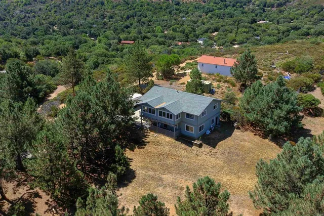 an aerial view of a house with a yard