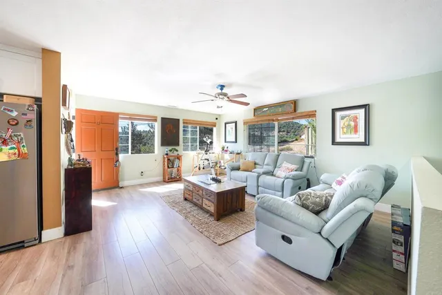 a living room with furniture and large windows