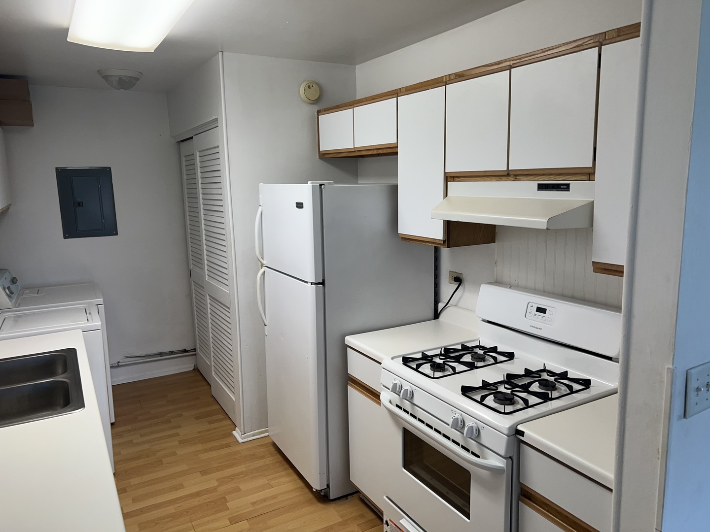 238 Algonquin Court, Unit D Bolingbrook, IL 60440 - Photo 4 of 13 a kitchen with a stove a refrigerator and a wooden cabinets