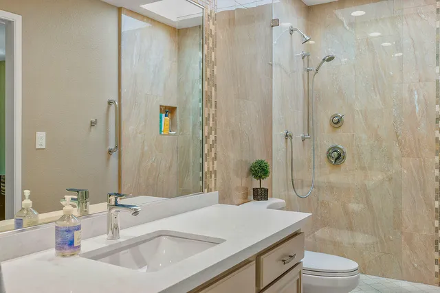 a bathroom with a sink toilet and shower