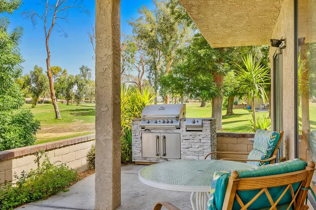 a backyard of a house with a fountain and trees