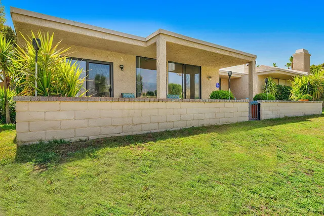 a view of house with backyard