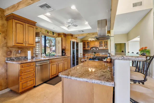 a kitchen with sink refrigerator and cabinets