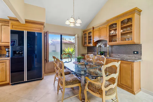a view of a dining room with furniture and chandelier