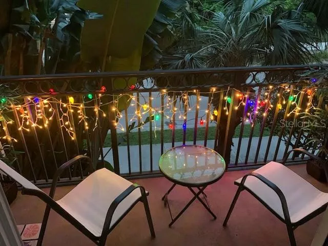 a view of a chairs and table in backyard