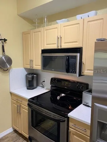a kitchen with stainless steel appliances a stove and a microwave