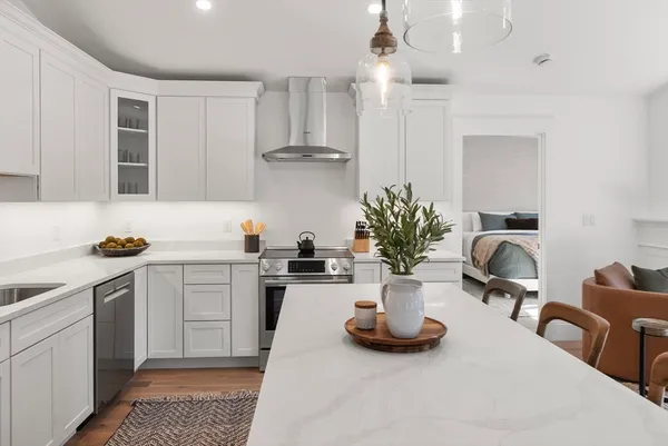 a kitchen with stainless steel appliances granite countertop a sink stove and refrigerator
