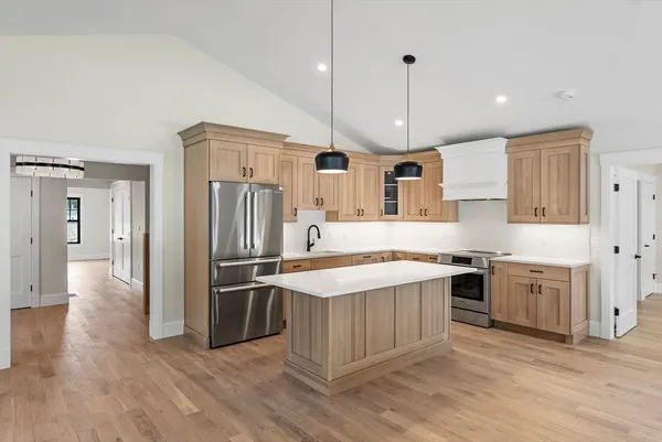 a kitchen with a sink stove and cabinets