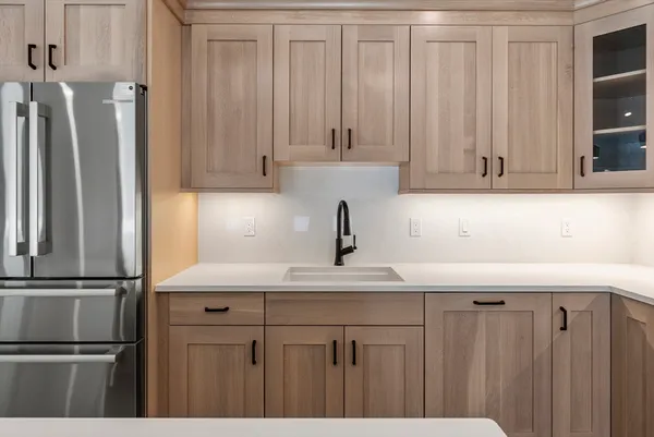 a kitchen with sink cabinets and wooden floor