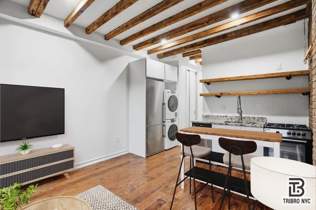 a dining room with furniture and wooden floor
