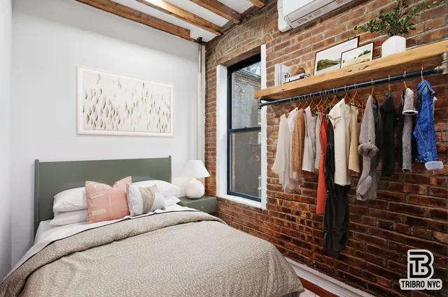 a bedroom with a bed and walk in closet