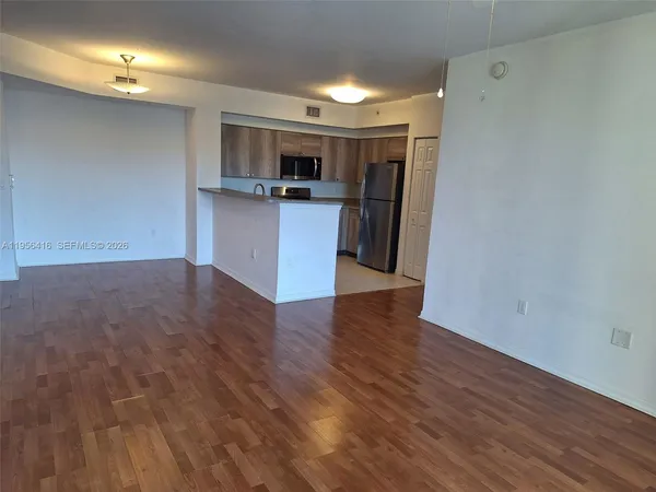 a view of kitchen with cabinets and wooden floor
