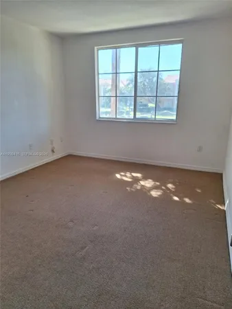 an empty room with a empty space and windows