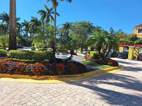 a view of a swimming pool with a lawn chairs and plants