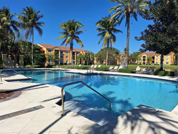 a front view of a house with swimming pool and patio