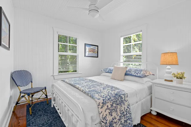 a bedroom with a bed chair and window