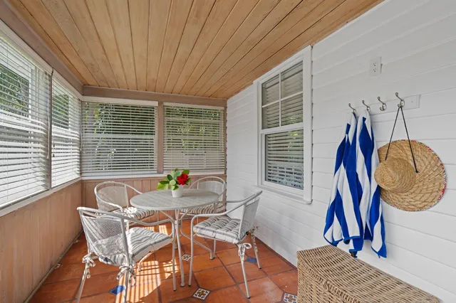 a view of a dining room with furniture and window