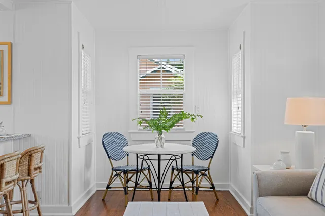 a dining room with furniture and wooden floor
