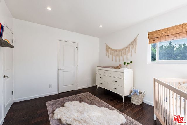 a room with a dresser and a window