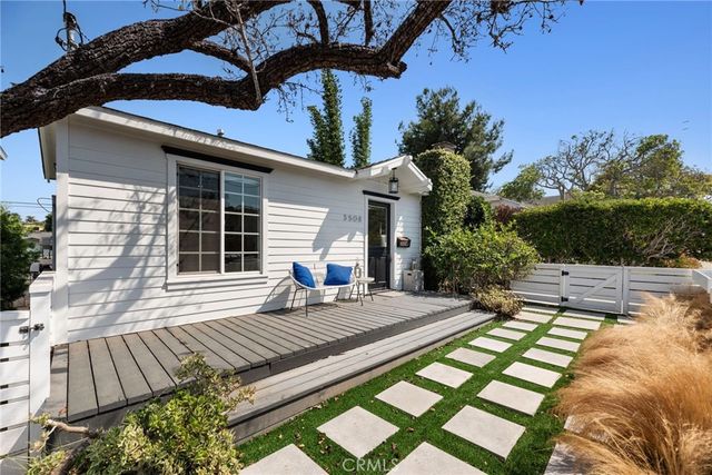 a view of a house with backyard and sitting area
