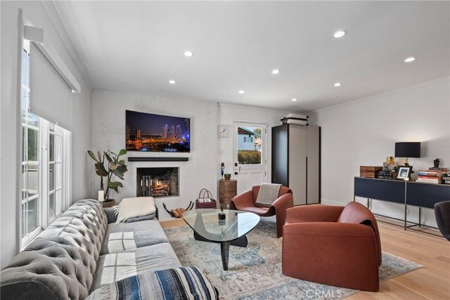 a living room with fireplace furniture and a flat screen tv